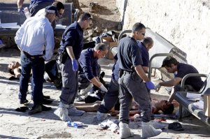 Israeli police officers inspect the body of a Palestinian at the scene of  a shooting attack near the Damascus gate, Jerusalem's Old City, Wednesday, Feb. 3, 2016. Three Palestinians carrying automatic weapons, explosive devices and knives shot and stabbed two Israeli security officers in Jerusalem on Wednesday, wounding both before police shot and killed the attackers, police said. (AP Photo/Mahmoud  Illean)