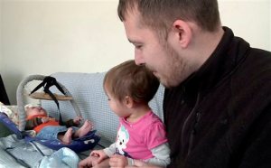 In this Friday, Feb. 5, 2016 image from video, Luke Waid discusses the lead-contamination in Flints water as he watches his 2-year-old daughter, Sophia, and infant son, Luke Jr, in their Flint, Mich., home. A federal lawsuit filed Monday, Feb. 8, 2016, seeks unspecified damages from Michigan Gov. Rick Snyder, the state of Michigan and city of Flint claiming Sophia has been sickened by the citys water. (AP Photo/Mike Householder)