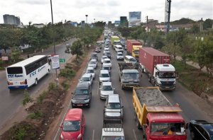 FILE - In this Tuesday, April 14, 2015 file photo, drivers sit in queues of traffic on a highway in downtown Nairobi, Kenya.  Taxi operators in Kenya want the government to stop operations of ride sharing app Uber, which has risen in popularity because of its cheaper fares, and Kenya police say they have launched investigations into allegations of attacks on Uber drivers. (AP Photo/Sayyid Azim, File)