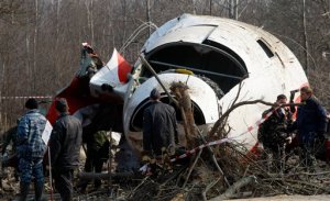 FILE - In this April 14, 2010 file photo emergency ministry workers preparing to load the wreckage of the Polish presidential plane on a  transporter just outside the Smolensk airport, western Russia, Poland's government has opened a new investigation into the 2010 plane crash in Russia that killed President Lech Kaczynski, the twin brother of the chairman of the country's ruling right-wing party. Defense Minister Antoni Macierewicz announced the new investigation Thursday Feb. 4, 2016  in Warsaw, saying the original investigation by Polish authorities was riddled with "mistakes" and "abnormalities."  (AP Photo/Mikhail Metzel)