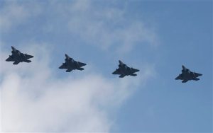 Four U.S. F-22 stealth fighters fly over Osan Air Base in Pyeongtaek, South Korea, Wednesday, Feb. 17, 2016. Four U.S. F-22 stealth fighters flew over South Korea on Wednesday in a clear show of power against North Korea, a day after South Korea's president warned of the North's collapse amid a festering standoff over its nuclear and missile ambitions. (AP Photo/Lee Jin-man)