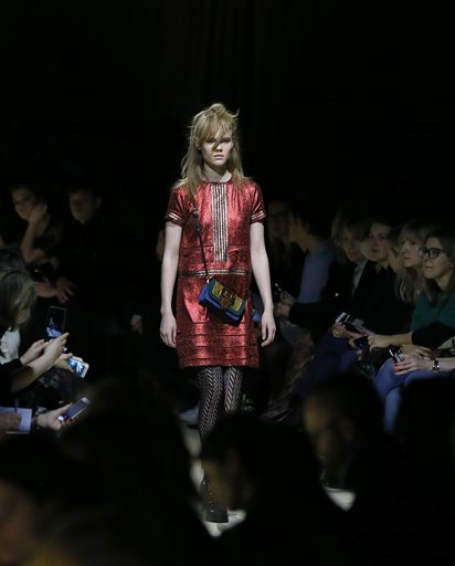A model displays a design during the Burberry Autumn/Winter show at London Fashion Week, Monday, Feb. 22, 2016. As the fashion world comes to London for its semi-annual round of minutely choreographed catwalk shows, luxury designers are shaking up the traditional show and rethinking the way they reach customers to adapt to the age of social media and e-commerce. (AP Photo/Kirsty Wigglesworth)