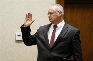 FILE - In this Feb. 15, 2016, file photo, Gatlinburg, Tenn., Detective Rodney Burns is sworn in as a witness before Judge Robert Philyaw during a preliminary hearing in Chattanooga for Ooltewah High School officials accused of failing to report a sexual assault. The teen's injuries outraged the Chattanooga prosecutor: Police said three older members of the basketball team shoved a pool cue into the boy's rectum, causing injuries that required emergency surgery, while hazing him and three other teammates on a trip to a tournament. But the detective from Gatlinburg, where the boy was injured, testified the case was overblown in the media. The jarring disconnect between views of the attack ignited an unusual public dispute between law enforcement agencies. (Dan Henry/Chattanooga Times Free Press via AP, File) THE DAILY CITIZEN OUT; NOOGA.COM OUT; CLEVELAND DAILY BANNER OUT; LOCAL INTERNET OUT; MANDATORY CREDIT