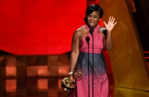 In this Sunday, Sept. 20, 2015 file photo, Uzo Aduba accepts the award for outstanding supporting actress in a drama series for "Orange Is The New Black" at the 67th Primetime Emmy Awards at the Microsoft Theater in Los Angeles. In one of the exhaustive and damning reports on diversity in Hollywood, a new study finds that the films and television produced by major media companies are whitewashed, and that an epidemic of invisibility runs top to bottom through the industry for women, minorities and LGBT people. A study to be released Monday, Feb. 22, 2016, by the Media, Diversity and Social Change Initiative at the University of Southern Californias Annenberg School for Communication and Journalism offers one of the most wide-ranging examinations of the film and television industries, including a pointed inclusivity index of 10 major media companies - from Disney to Netflix - that gives a failing grade to every movie studio and most TV makers. (Photo by Chris Pizzello/Invision/AP, File)