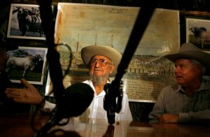 FILE - In this March 26, 2008 file photo, Ramon Castro, left, the elder brother of Cuba's Fidel Castro, speaks with journalists as cattleman John Parke Wright IV, of Florida, listens during the 13th Boyeros Cattleman's Fair in Havana, Cuba. Castro, a lifelong rancher and farmer who bore a strong physical resemblance to his younger brother, Fidel, died Tuesday, Feb. 23, 2016, state media announced. He was 91. (AP Photo/Javier Galeano, File)