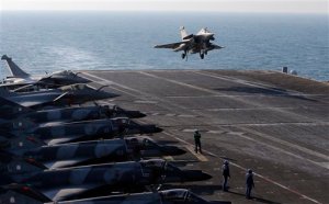 A Rafale fighter jet lands after a mission, on France's flagship Charles de Gaulle aircraft carrier in the Persian Gulf, Wednesday, Jan. 13, 2016. The Charles de Gaulle joined the U.S.- led coalition against Islamic State group in November, as France intensified its airstrikes against extremist sites in Syria and Iraq in response to Islamic State group threats against French targets. (AP Photo/Christophe Ena)