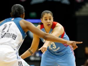 FILE - In this July 31, 2015 file photo, Atlanta Dream guard Shoni Schimmel (23) tries to set up a play against Minnesota Lynx guard Renee Montgomery (21) during a WNBA basketball game in Minneapolis. A court-side confrontation has led the Santa Fe, N.M., Indian School to fire their two basketball coaches, both the parents of Shoni Schimmel. They say racial remarks set off the dispute. The school's varsity head coach Ceci Moses, and her husband and assistant coach Rick Schimmel were let go Sunday, Feb. 21, 2016, following a game the previous week against St Michael's High School. (AP Photo/Stacy Bengs, File)