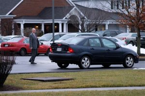 A worker directs traffic in the parking lot of a Blacksburg, Virginia, funeral home on Wednesday, Feb. 3, 2016. McCoy Funeral Home hosted visitation for 13-year-old Nicole Lovell, who authorities say was stabbed to death after she disappeared from her home. Her body was found in North Carolina, and two Virginia Tech students are charged in her death. (AP Photo/Skip Foreman)
