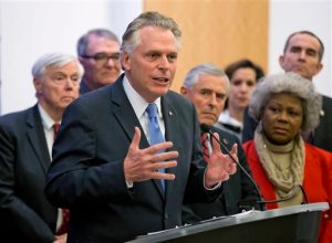 Virginia Gov. Terry McAuliffe is joined by members of the House and Senate as he announces a compromise on a set of gun bills at the Capitol in Richmond, Va., Friday, Jan. 29, 2016. (AP Photo/Steve Helber)