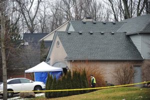 Police and fire officials investigate a house fire that killed five people at a home in Novi, Mich., Sunday, Jan. 31, 2016. Authorities say five restaurant workers were killed in the house fire near Detroit. The cause of the blaze is under investigation. (Brandy Baker/Detroit News via AP) DETROIT FREE PRESS OUT; HUFFINGTON POST OUT; MANDATORY CREDIT