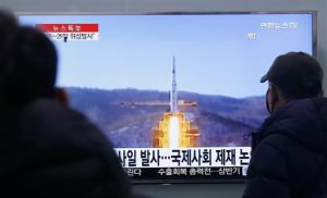 South Koreans watch a TV news program with a file footage about North Korea's rocket launch plans, at Seoul Railway Station in Seoul, South Korea, Wednesday, Feb. 3, 2016. South Korea warned on Wednesday of "searing" consequences if North Korea doesn't abandon plans to launch a long-range rocket that critics call a banned test of ballistic missile technology. The headline on the screen reads "North Korea plans to launch a missile." (AP Photo/Ahn Young-joon)