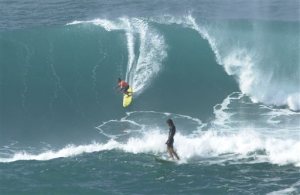 FILE  In this Jan. 7, 2002 file photo provided by World Surf League,  Clyde Aikau, left, brother of Eddie Aikau, drops into a wave as Tony Ray, of Australia, finishes during the Quiksilver In Memory of Eddie Aikau big wave surf competition at Waimea Bay, Hawaii. Event organizers say the competition will again take place Wednesday, Feb. 10, 2016, for the first time in over six years as the surf conditions on the North Shore of Oahu are expected to meet the strict minimum requirements. (Ronen Zilbermen/World Surf League via AP, File)