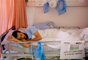 FILE - This Wednesday, Feb. 10, 2016. file photo shows hunger striking Palestinian journalist prisoner Mohammed al-Qeq, lying in a hospital bed at the Emek Medical Center in Afula, Al-Qeq family said he ended hunger strike after  a record 94 days and that he will be released in three months. (AP Photo/Ariel Schalit, File)