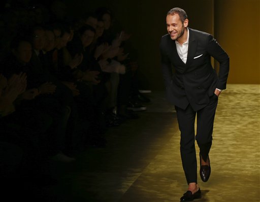 FILE -- In this photo taken on Jan. 17, 2016, Italian Fashion designer Massimiliano Giornetti acknowledges the applause of the audience at the end of the Salvatore Ferragamo men's Fall-Winter 2016-2017 show unveiled in Milan, Italy. Salvatore Ferragamo's creative director, Massimiliano Giornetti, is leaving the fashion house after 16 years. Giornetti entered Ferragamo in 2000 as menswear designer and in 2011 became the brand's creative director. (AP Photo/Luca Bruno)