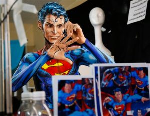 In this March 19, 2016 photo, Kay Pike transforms herself using body paint and latex into Superman while live streaming at her home in Calgary, Alberta. The Canadian artist turns her body into different characters for an Internet audience. (Jeff McIntosh/The Canadian Press via AP) MANDATORY CREDIT