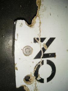 In this Feb. 28, 2016 image provided by Blaine Gibson and the Australian Transport Safety Bureau (ATSB), a piece of aircraft debris with the words "NO STEP" is photographed after it was found washed up on a beach in Mozambique. Debris that washed up in Mozambique has been tentatively identified as a part from the same type of aircraft as the missing Malaysia Airlines Flight 370, a U.S. official said. (Blaine Gibson/ATSB via AP) MANDATORY CREDIT, NO SALES