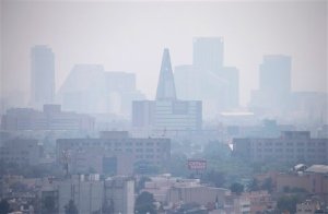 Smog blankets scyscrapers along Paseo de la Reforma in Mexico City, Thursday, March 17, 2016. An air pollution alert in greater Mexico City was extended to its fourth day, with authorities saying that despite slight improvements smog levels remained at almost 1 1/2 times acceptable limits in some areas. (AP Photo/Rebecca Blackwell)