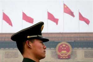 A Chinese paramilitary policeman stands guard near the Great Hall of the People in Beijing, Friday, March 4, 2016. China said Friday it will boost military spending by about 7 to 8 percent this year, the smallest increase in six years, reflecting slowing economic growth and a drawdown of 300,000 troops as Beijing seeks to build a more streamlined, modern military. (AP Photo/Andy Wong)