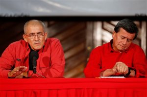 Antonio Garcia, chief negotiator of Colombia's rebel group, the National Liberation Army (ELN), left, and fellow rebel Pablo Beltran give a press conference in Caracas, Venezuela, Wednesday, March 30, 2016. Colombia and the country's second-largest rebel group announced Wednesday that they will hold peace talks, heightening expectations for a definitive end to a half-century of political violence in the Andean nation. Negotiations will kick off in Ecuador and then possibly continue in Venezuela, Brazil and Chile and Cuba. (AP Photo/Ariana Cubillos)