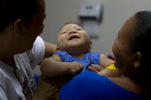 FILE - In this Feb. 25, 2016 file photo, Caio Julio Vasconcelos who was born with microcephaly undergoes physical therapy at the Institute for the Blind in Joao Pessoa, Brazil. Researchers say the Zika virus may be linked to a wider variety of grave outcomes for developing babies than previously reported and that threats can come at any stage of pregnancy.  (AP Photo/Andre Penner, File)