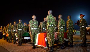 FILE - In this Monday, Jan. 18, 2016 file photo, military pallbearers stand to attention next to the coffins of four Kenyan soldiers who were killed in Somalia, at a ceremony to receive their bodies which were airlifted to Wilson Airport in Nairobi, Kenya. Somalia's president Hassan Sheikh Mohamud said Wednesday, Feb. 24, 2016 that at least 180 Kenyan soldiers were killed in Somalia in an extremist attack on their base in January by al-Qaida affiliate al-Shabab. (AP Photo/Ben Curtis, File)