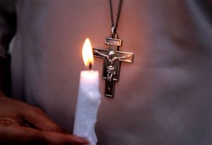 A Pakistani nun holds a candle during a vigil for victims of Sunday's deadly suicide bombing in a park, Monday, March 28, 2016 in Lahore, Pakistan. Pakistan's prime minister on Monday vowed to eliminate perpetrators of terror attacks such as the massive suicide bombing that targeted Christians gathered for Easter the previous day in the eastern city of Lahore, killing at least 70 people. (AP Photo/K.M. Chaudary)