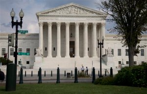 In this photo taken Sept. 18, 2014, the Supreme Court Building is seen in Washington. Four liberal justices on a short-handed Supreme Court seem sympathetic to arguments that Puerto Rico officials should be allowed to restructure the debt of its financially struggling public utilities.  (AP Photo/Carolyn Kaster)