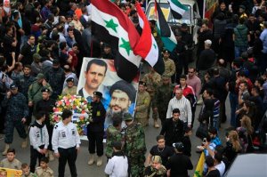 Relatives and comrades of Hezbollah senior commander, Ali Fayyad, who was killed last week during an offensive by Syrian troops and Hezbollah fighters in Syria, carry pictures of Syrian President Bashar Assad, left, and Hezbollah leader Sheikh Hassan Nasrallah during his funeral procession in the southern Lebanese village of Ansar, Lebanon, Wednesday, March 2, 2016. Fayyad was a Hezbollah veteran who had led major battles against the Israeli army in south Lebanon. A Saudi-led bloc of six Gulf Arab nations formally branded Hezbollah a terrorist organization on Wednesday, ramping up the pressure on the Lebanese militant group fighting on the side of President Bashar Assad in Syria. (AP Photo/Mohammed Zaatari)