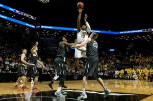 Virginia Commonwealth forward Mo Alie-Cox (12) goes to the basket against Davidson forward Peyton Aldridge and forward Nathan Ekwu (1) during the first half of an NCAA college basketball game during the semifinals of the Atlantic 10 men's tournament, Saturday, March 12, 2016, in New York. (AP Photo/Mary Altaffer)