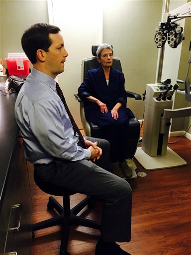 FOR RELEASE SATURDAY, MARCH 12, 2016, AT 9:00 A.M. EST.- Vistar Eye Centers Dr. Stuart Tims examines Patricia Maggard, 74, of Narrows, to determine how her right eye has healed since he placed a tiny telescope in it to improve her vision. (Luanne Rife/The Roanoke Times via AP)