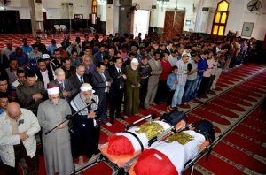 In this photo provided by the Ismailia Governor's office, citizens and dignitaries attend the funeral of Mohammed Taha Hassan Bakhit and Bassam Hindawi, two victims of a Saturday mortar attack on a checkpoint south of northern Sinais provincial capital of el-Arish, at a mosque in Ismailiya, Egypt, Egypt, Sunday, March 20, 2016. Egypts interior ministry said the death toll in the attack has risen to at least 15 policemen, include three officers. A Sinai-based Islamic State affiliate has claimed responsibility for the attack, according to a statement circulated on social media. The Associated Press could not independently verify the claim. (Ismailia Governor's office via AP)