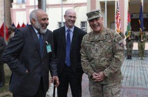 Outgoing Commander of Resolute Support forces and United States forces in Afghanistan, U.S. Army General John Campbell, right, and Afghan Acting Defence Minister Mohammad Masoom Stanikzai, left, laugh during a change of command ceremony in Resolute Support headquarters in Kabul, Afghanistan, Wednesday, March 2, 2016. (AP Photo/Rahmat Gul)
