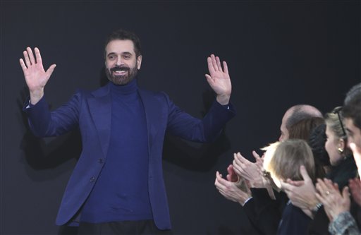 FILE -- In this file photo taken on March 3 2013, Italian fashion designer Ennio Capasa reacts after the presentation of  Costume National's Ready to Wear's Fall-Winter 2013-2014 fashion collection, presented in Paris. Costume National founder and creative director Ennio Capasa has stepped down following the takeover of the brand by its Japanese partner, Sequedge. (AP Photo/Thibault Camus)