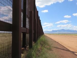 This Wednesday, Sept. 16, 2015 photo shows a part of the border fence near Naco, Ariz., during a tour of the border hosted by the Cochise County Sheriff's Office. Ranchers in this area say the border needs a wall to keep out drug smugglers and illegal border crossers. (AP Photo/Astrid Galvan)