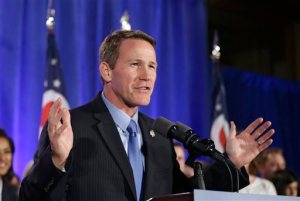 FILE - In this Nov. 4, 2014, file photo, Ohio Secretary of State Jon Husted speaks to supporters at an Ohio Republican Party celebration in Columbus, Ohio.  A policy for Ohio's youngest voters is under dispute in the swing state, causing confusion and prompting two lawsuits days before the primary election. Ohio law allows 17-year-olds who will be 18 before the fall election to vote in next week's primary, with some exceptions. Young Ohio voters can decide on congressional, legislative and mayoral contenders but can't vote on tax levies, ballot issues or a political party's central committee candidates. (AP Photo/Tony Dejak, File)