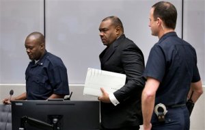 Jean-Pierre Bemba enters the court room of the International Criminal Court in The Hague, Netherlands, Monday, March 21, 2016. The International Criminal Court is passing judgment on former Congolese vice president Bemba on charges of commanding a militia that went on a spree of murder, rape and pillage in Central African Republic more than a decade ago. The verdicts being delivered Monday afternoon focus on the responsibility of a military commander for the actions of his troops. Bemba's long-running trial also was the first at the ICC to feature allegations of systematic sexual abuse by soldiers in a conflict. (AP Photo/Jerry Lampen, Pool)