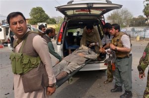 Afghan security forces carry an injured man after a suicide attack on the Indian consulate in the city of Jalalabad east of Kabul, Afghanistan, Wednesday, March 2, 2016. An Afghan official says two civilians have been killed and 19 wounded in an attempted car bomb attack on the Indian consulate in the eastern city of Jalalabad. An official at the Indian embassy in Kabul, Anil Kumar, says all consulate staff are safe. (AP Photo/Mohammad Anwar Danishyar)