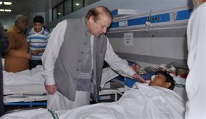 In this photo released by Press Information Department, Pakistan's Prime Minister Nawaz Sharif talks to an injured victim of Sunday's suicide bombing during his visit to a local hospital in Lahore, Pakistan, Monday, March 28, 2016. Pakistans prime minister on Monday vowed to eliminate perpetrators of terror attacks such as the massive suicide bombing that targeted Christians gathered for Easter the previous day in the eastern city of Lahore, killing 70 people. (AP Photo/Press Information Department via AP)