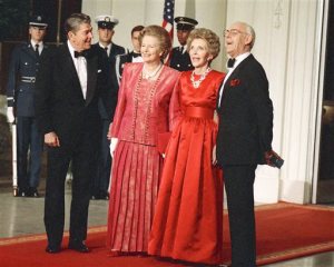 FILE - In this Nov. 16, 1988 file photo, President Ronald Reagan, left, and first lady Nancy Reagan, second right, appear with British Prime Minister Margaret Thatcher, second left, and her husband, Dennis at a state dinner at the White House in Washington. Nancy Reagan died Sunday, March 6, 2016, at the age of 94. (AP Photo/Charles Tasnadi, File)