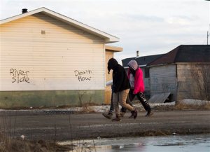 Teenage girls walk through the streets in the northern Ontario First Nations reserve in Attawapiskat, Ontario, Canada, on Monday, April 18, 2016. Natan Obed, president of Inuit Tapiriit Kanatami, the leader of the country's national Inuit organization says his people are dealing with devastating rates of suicide. Obed said he hopes the government will move forward on a plan designed specifically to help Inuit people. (Nathan Denette/The Canadian Press via AP) MANDATORY CREDIT