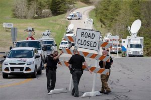 FILE - In this Friday, April 22, 2016 file photo, authorities set up road blocks at the intersection of Union Hill Road and Route 32 at the perimeter of a crime scene, in Pike County, Ohio. As the investigation into the killings of eight family members in rural Ohio enters its fifth day, more details are being released. Pike County Prosecutor Rob Junk told The Columbus Dispatch Monday, April 25, 2016, that the marijuana operations discovered at three of the four crime scenes included a grow-house sheltering hundreds of plants. (AP Photo/John Minchillo, File)