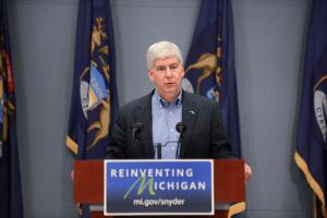 Gov. Rick Snyder speaks to the press on Wednesday, April 20, 2016 in Lansing, Mich. Months after officials conceded that a series of bad decisions had caused a disaster, charges were filed against a pair of state Department of Environmental Quality employees and a local water treatment supervisor and stem from an investigation by the office of the attorney general. (Julia Nagy/Lansing State Journal via AP)