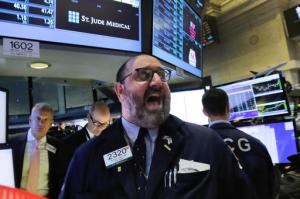 Specialist Peter Giacchi calls out prices for St. Jude Medical on the floor of the New York Stock Exchange, Thursday, April 28, 2016. Abbott Laboratories will spend $19.3 billion to buy St. Jude Medical Inc. in a cash-stock deal that aims to strengthen the medical device maker's stake in cardiovascular care. (AP Photo/Richard Drew)