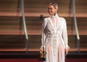 FILE - In this Feb. 15, 2016, file photo, Beyoncé presents the award for record of the year at the 58th annual Grammy Awards in Los Angeles. After the recent debut of her visual album Lemonade on HBO, a Ticketmaster representative told The Associated Press on Wednesday, April 27, that the ticket outlet company saw searches for Beyoncés concerts increased by 116 percent compared to last week. (Photo by Matt Sayles/Invision/AP, File)