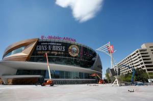 In this March 28, 2016, photo, workers finish construction outside of the T-Mobile Arena in Las Vegas. The latest multi-million dollar development on the Las Vegas Strip features a leafy outdoor pedestrian area, 20,000 seat arena and small theater. The arena is scheduled to open April 6. (AP Photo/John Locher)