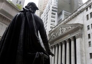 In this Oct. 2, 2014, file photo, the statue of George Washington on the steps of Federal Hall faces the facade of the New York Stock Exchange. U.S. stocks are sinking with the price of oil and precious metals Friday, April 1, 2016. Energy and mining companies are taking the biggest losses. Global stocks are also falling. Hotel operators Starwood and Marriott are sliding after Anbang Insurance, the Chinese company that sought to buy Starwood, walked away from its offer. (AP Photo/Richard Drew, File)