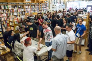 Fans line up to get autographs from members of the punk band NOFX at a book signing at Parnassus Books in Nashville, Tenn., on Tuesday, April 26, 2016. At front table from left are Erik "Smelly" Sandin, Aaron El Hefe Abeyta, Eric Melvin, and Fat Mike Burkett. (AP Photo/Erik Schelzig)