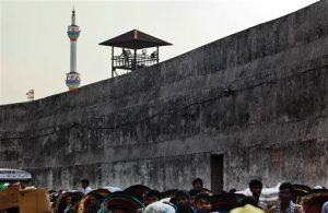 In this April 10, 2016 photo, a prison guard looks over a busy street adjoining the Dhaka Central Jail in Dhaka, Bangladesh. The government is closing its notorious 18th-century prison where sensational political killings over decades have targeted people on both sides of the South Asian country's 1971 war for independence from Pakistan. (AP Photo/ A.M. Ahad)