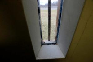 FILE - In this Feb. 25, 2016 file photo, fences with barbed wire are visible from the window of a cell in what prison officials describe as a disciplinary confinement area rather than solitary confinement, at the Rhode Island Department of Corrections High Security Center, in Cranston, R.I. Roberta Richman, a former warden who spent 33 years working in the state Department of Corrections who retired in 2012, testified Wednesday night, April 6, 2016, in favor of legislation that would limit the isolation of inmates to no more than 15 days at a time. "Too many inmates come out of isolation angrier and more dangerous than they were when they went in," Richman said. (AP Photo/Steven Senne, File)