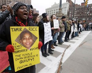 FILE - In this Nov. 25, 2014, file photo, demonstrators block Public Square in Cleveland, during a protest over the police shooting of Tamir Rice. The city of Cleveland has reached a settlement Monday, April 25, 2016, in a lawsuit over the death of Rice, a black boy shot by a white police officer while playing with a pellet gun. (AP Photo/Tony Dejak, File)